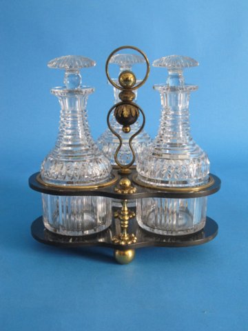 Three Glass Decanter & Black Lacquered Papier Mache & Ormolu Tantalus.George IV, circa 1825. - Click to enlarge and for full details.
